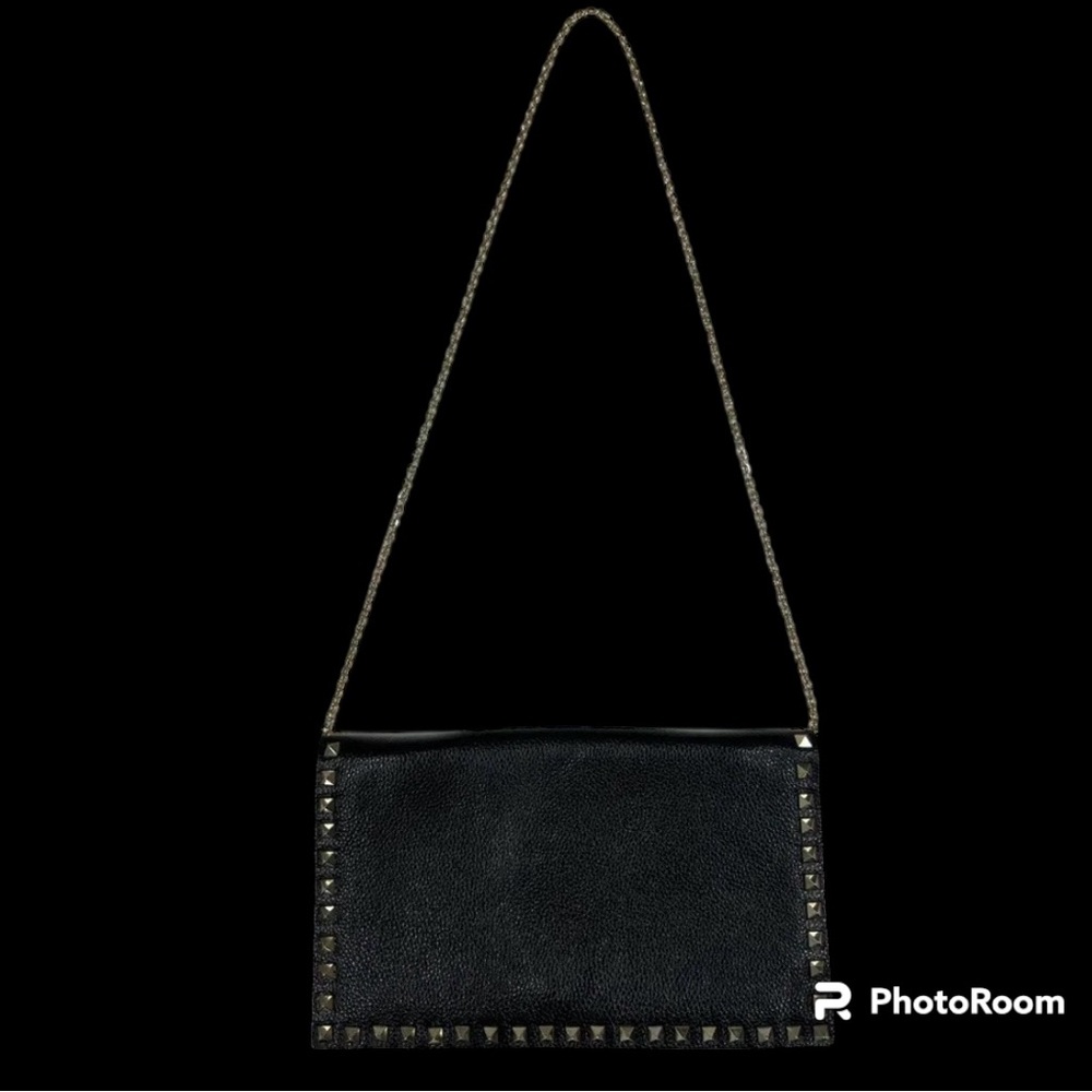 Chic black crossbody with studded accents. Features a sleek chain strap Leather